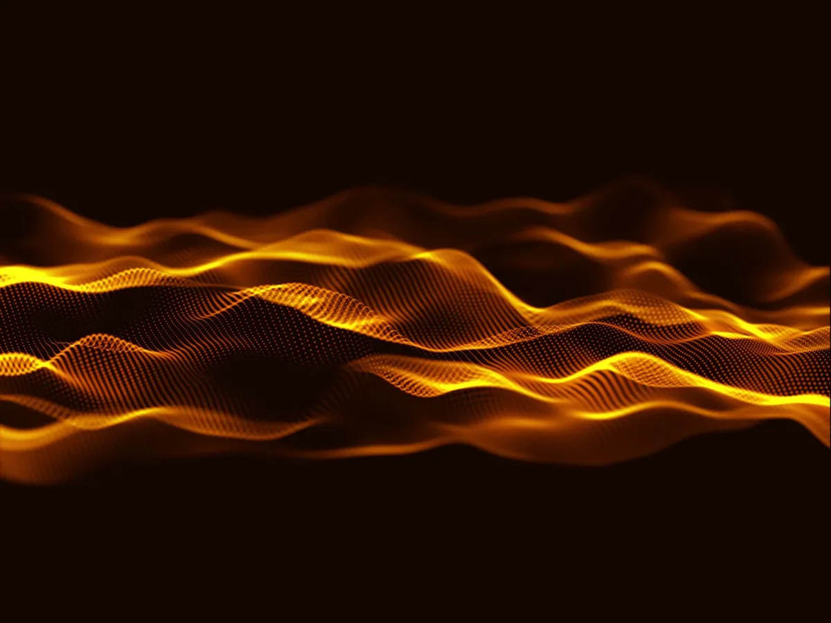 Abstract glowing amber wave of dots on a black background